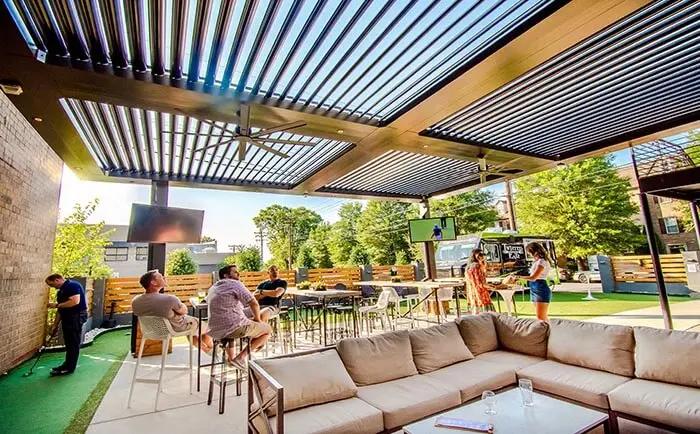 Outdoor living space covered by an automatic pergola