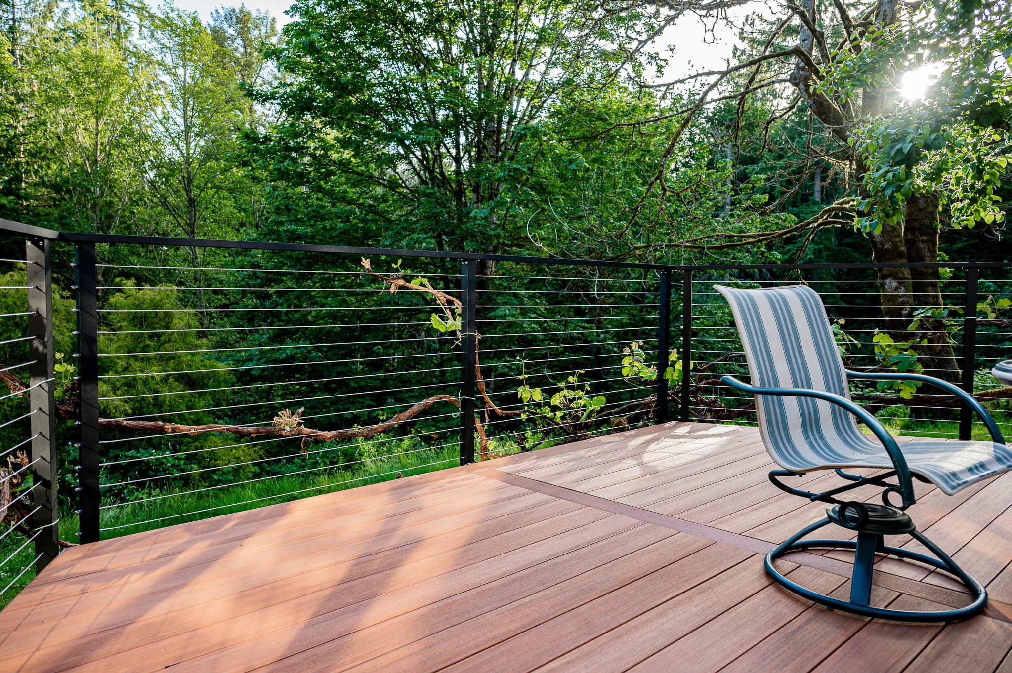 Horizontal cable railing installation in wooded land